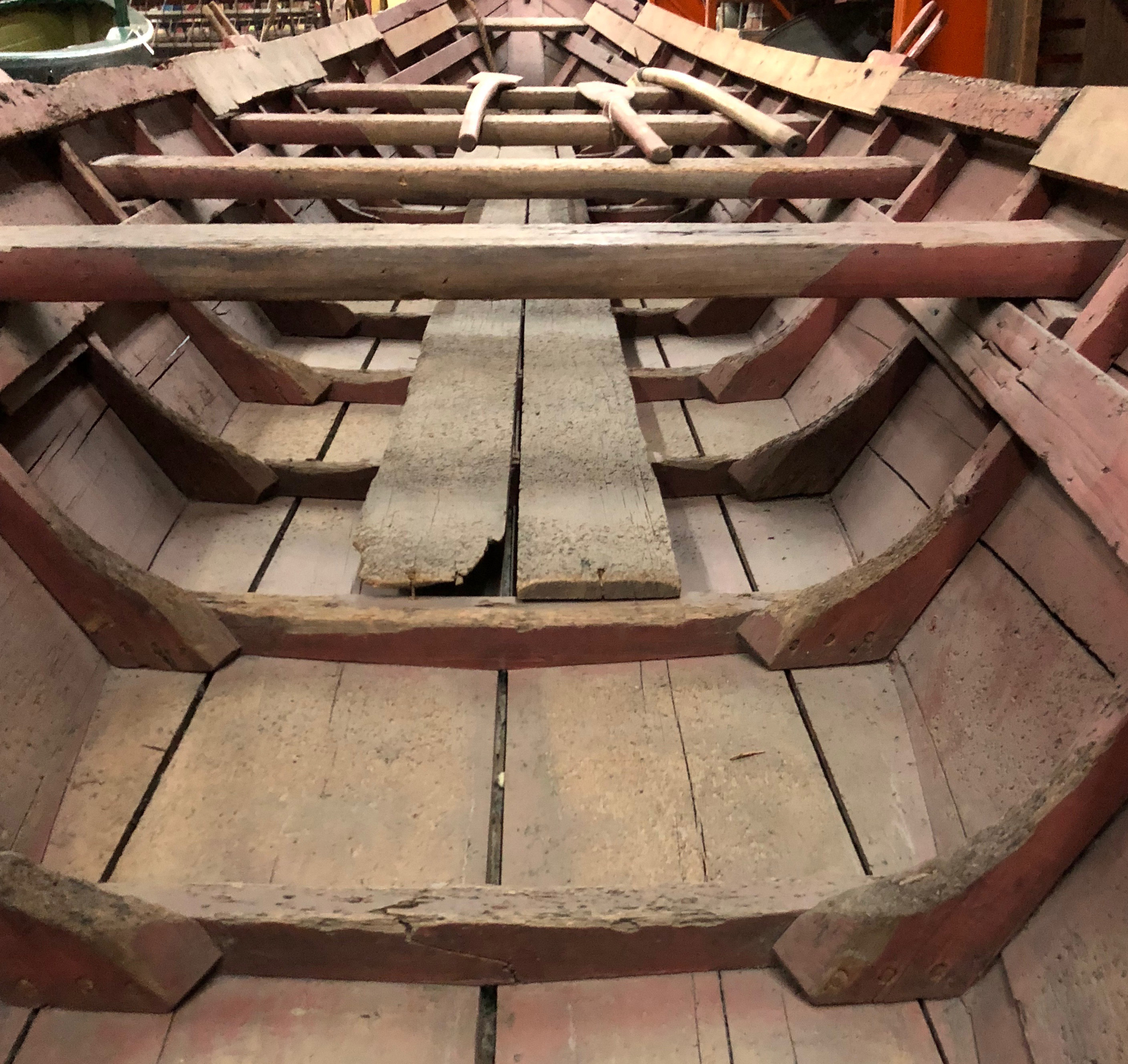 A colour photograph of the wooden ribs and base of a Cockburn Pointer Boat.